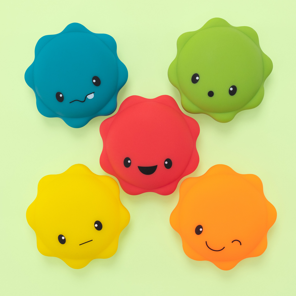 5 piece macaron bath toy overhead on a green background