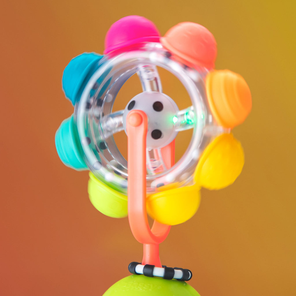 light up rainbow reel spinning on an orange background.