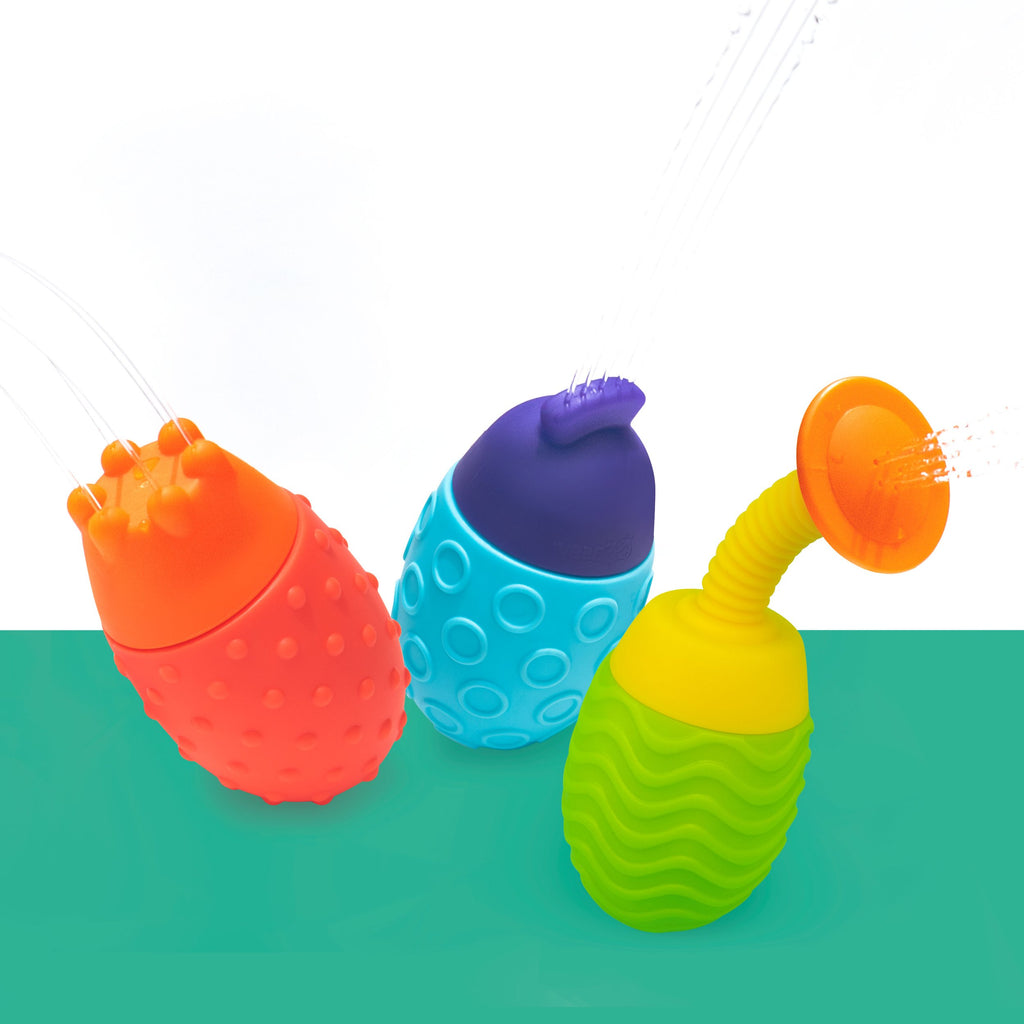 three oval shaped bath toys with unique textures and all have water coming out of them is different patterns