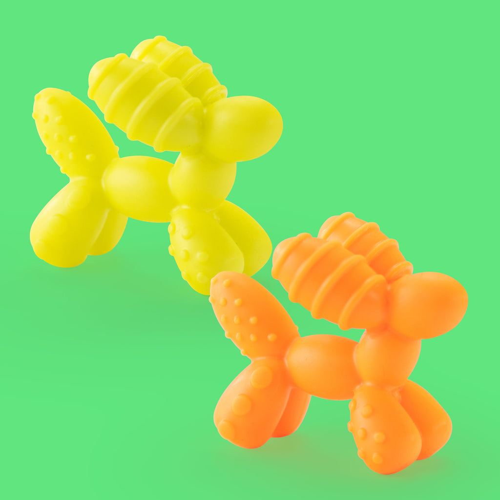 green background with yellow balloon dog teething toy and orange balloon dog teething toy