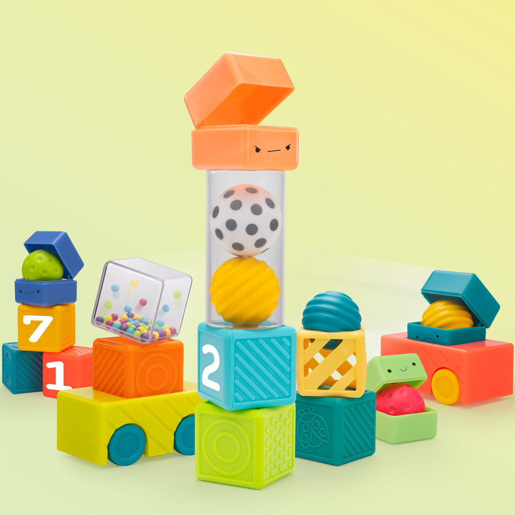 multicolored blocks stacked in different ways with a few balls and cars