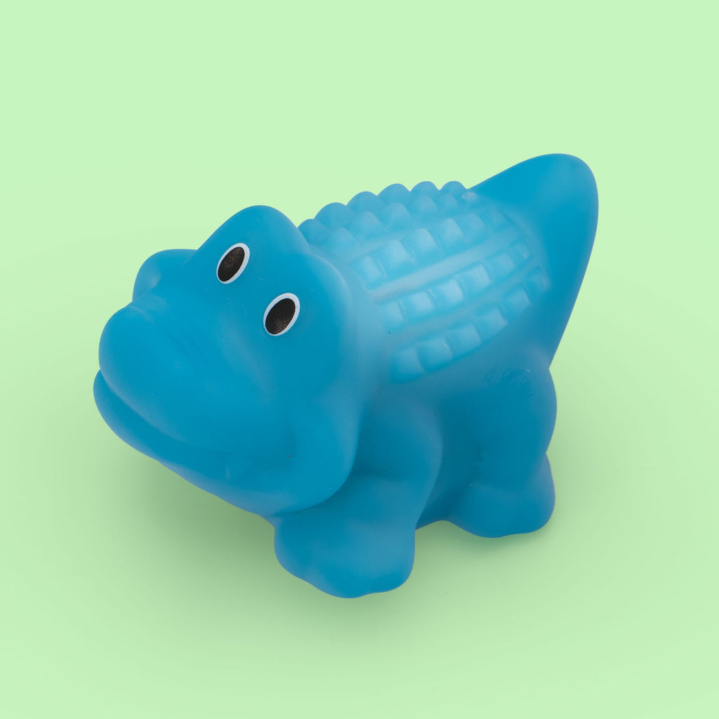 Blue alligator bath toy with big eyes lighting up on the back