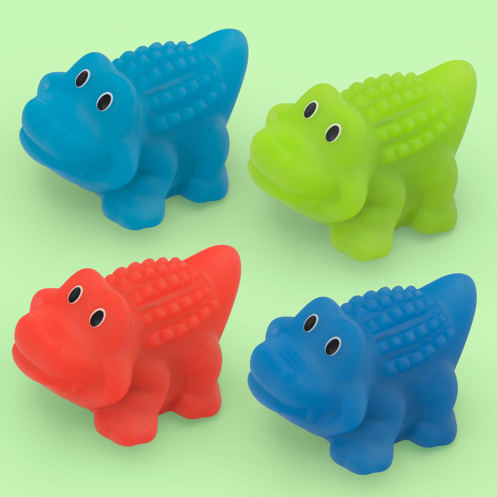 4 alligator bath toys in green blue and red. All with big eyes