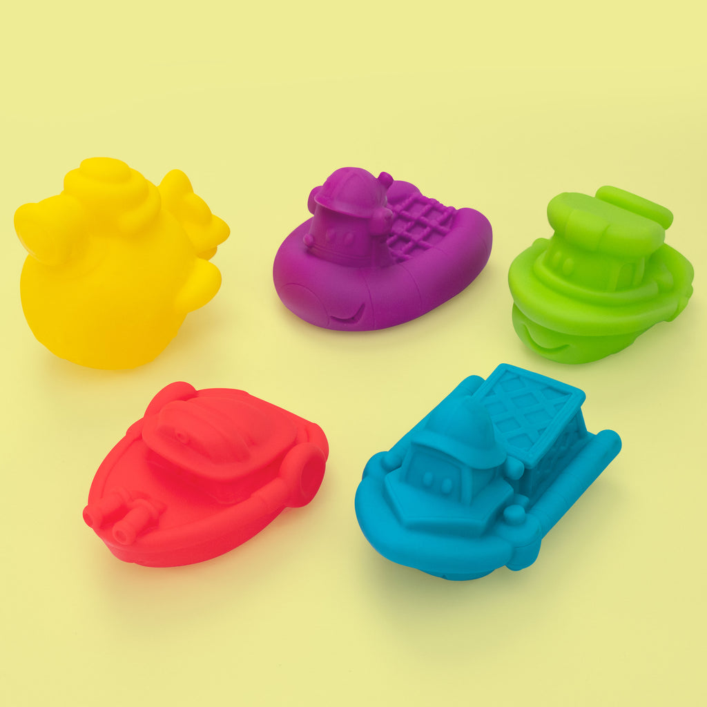 5 piece boat set. Yellow, purple, green, red, and blue boats on a yellow background. 