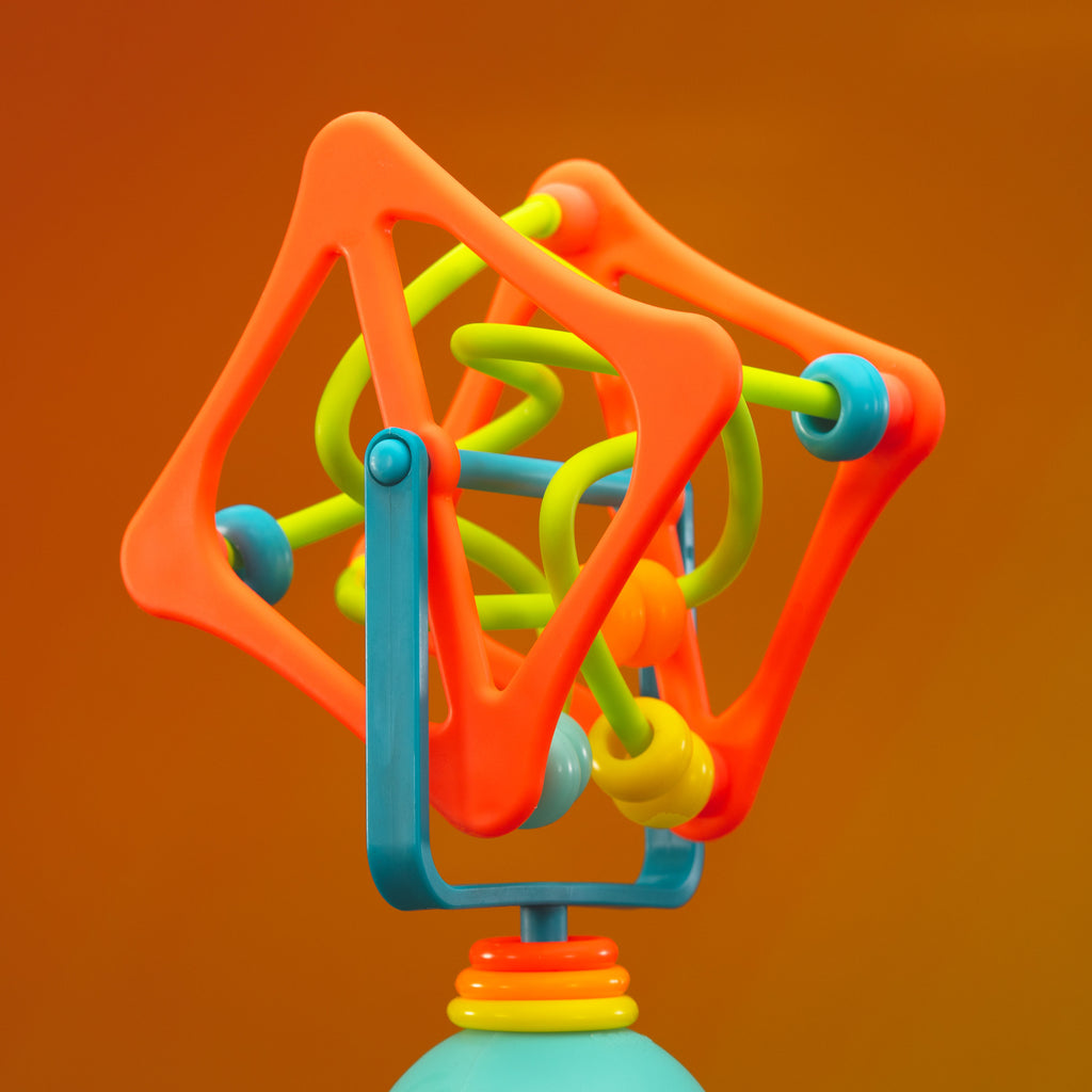 spinning cube tray toy on an orange background