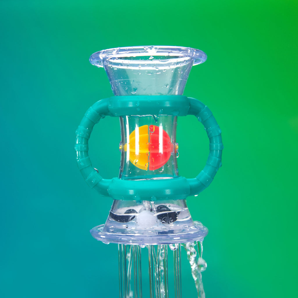 clear plastic bath toy in the shape of an hourglass with two teal handles on either side and water coming out of the bottom.