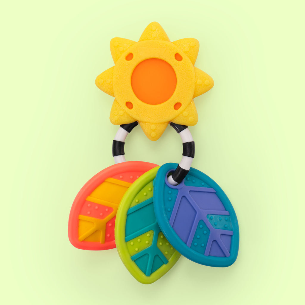 a sunshine silicone and plastic teether that has three multi-colored and textured leaf shaped teether attached to it and are linked together by a black and white striped piece.