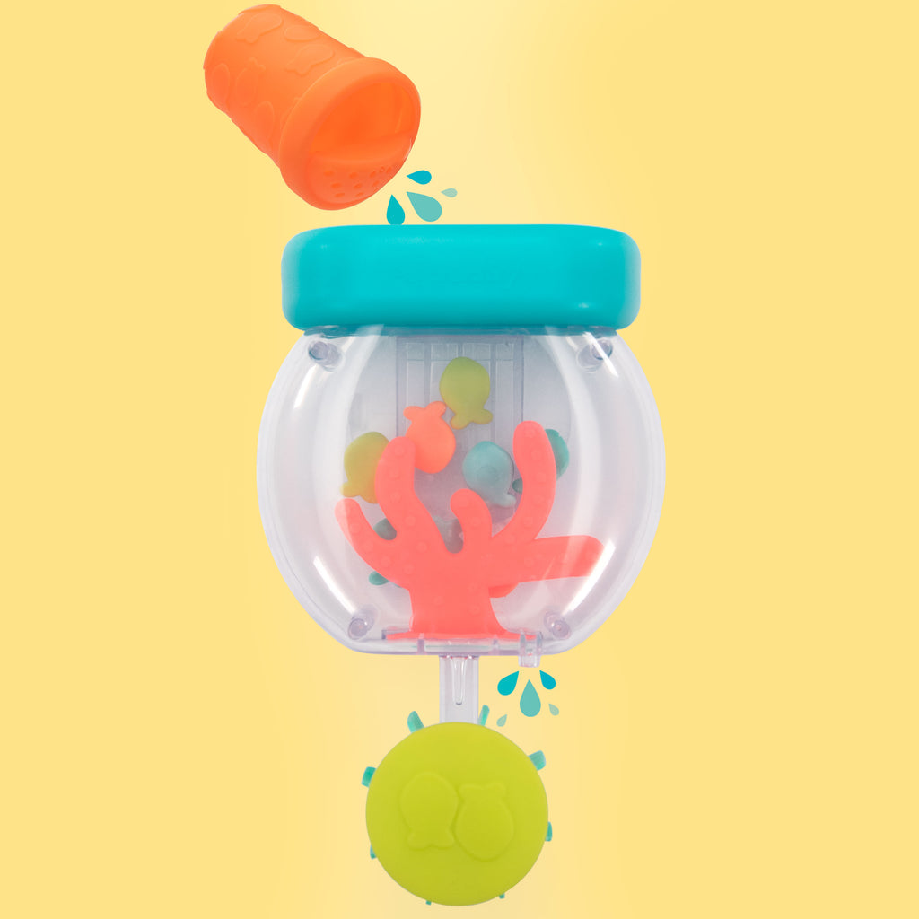 toy that looks like a fish bowl with coral and fish inside, and an orange "fish feeder" toy with water coming out of it