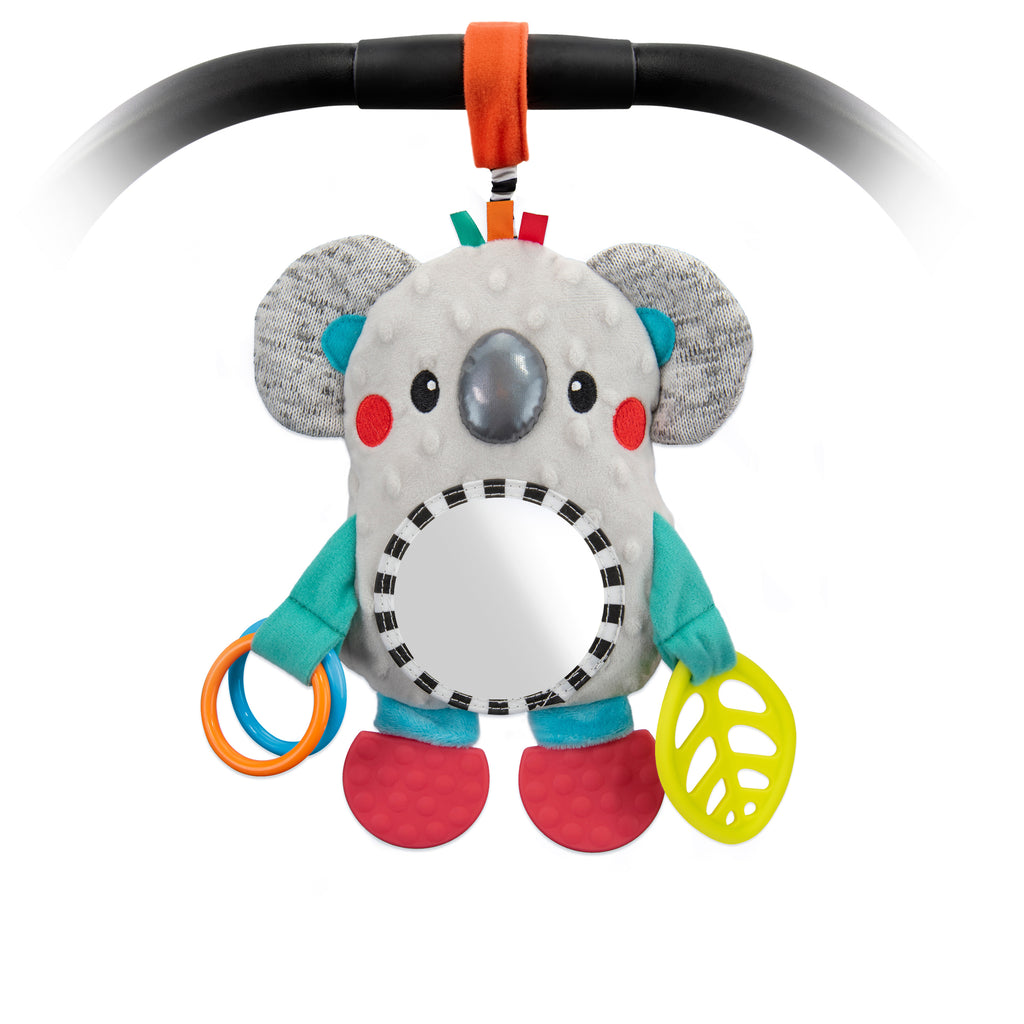 Soft koala baby toy, with a mirror belly, red teeth able feet, and rosy red cheeks. Hanging on a baby carrier