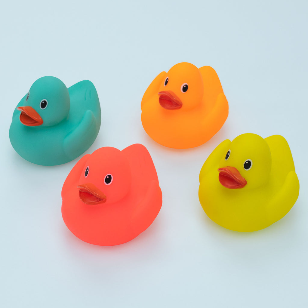 4 multi-colored rubber bath ducks with painted faces and beaks. 