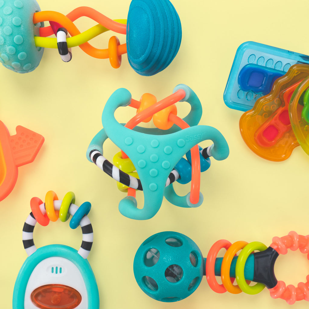 sensory toys collection shown overhead on a yellow background