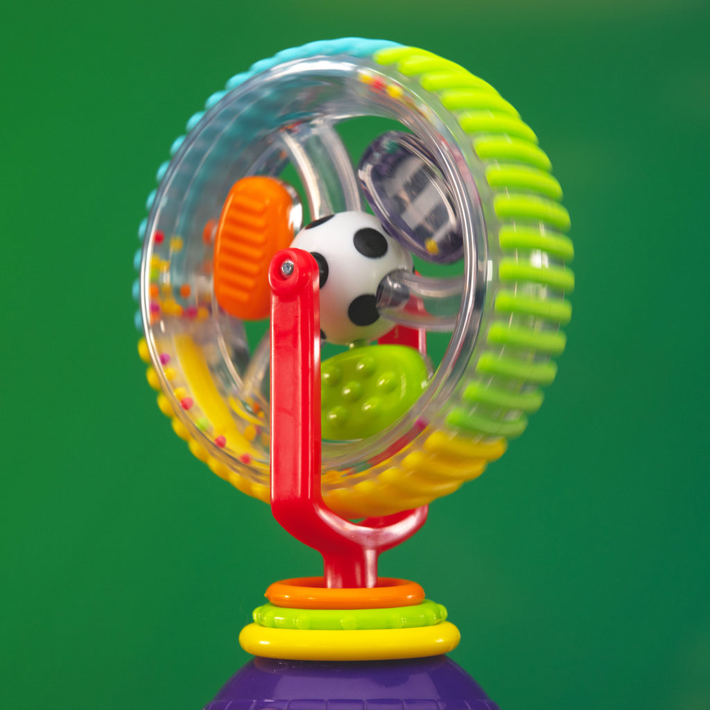 wonder wheel tray toy spinning on a green background